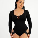 Mujer con body tanga negro de manga larga y escote redondo con gota.