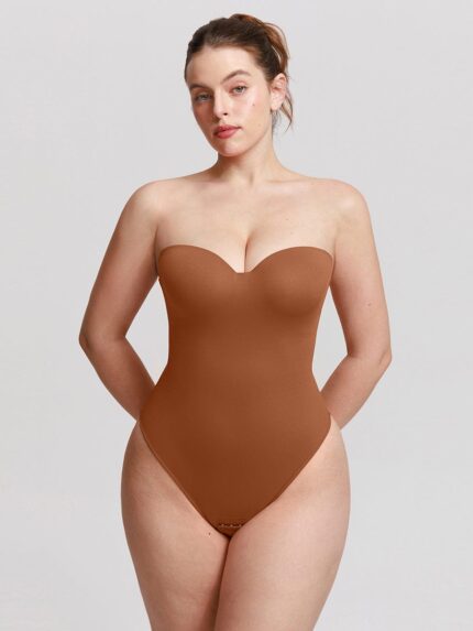 Mujer con body tanga marrón caramelo con aros y escote corazón.